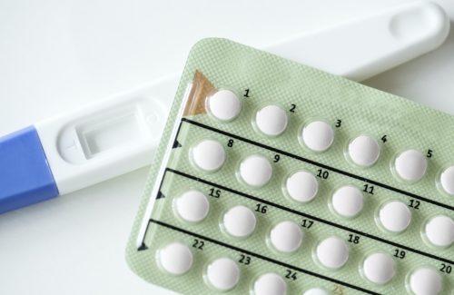 Closeup of pregnancy test and contraceptive pills birth control concept