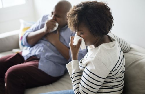 Woman sick and sneezing